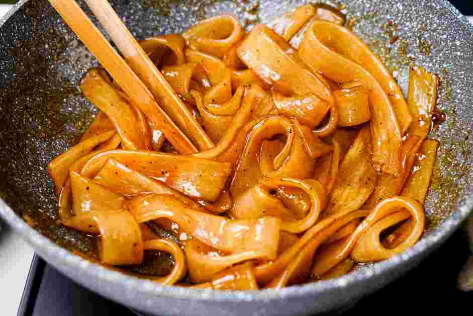 Pad See Ew Recipe: Heat the remaining two tablespoons of oil in the empty wok until shimmering and hot.