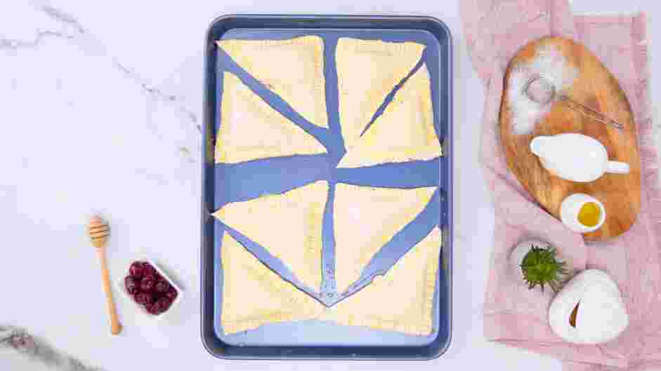 Cherry Turnovers Recipe: Use a pastry brush or wet paper towel to brush each pastry with the egg wash.