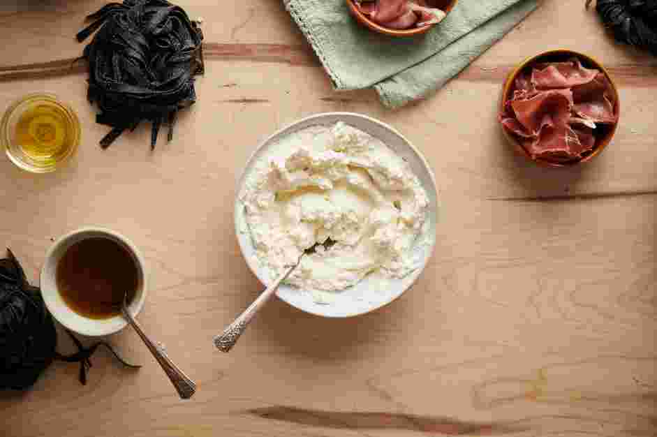 Squid Ink Pasta with Crispy Prosciutto and Truffle Honey Recipe: In the bowl of a food processor, add the ricotta and salt.