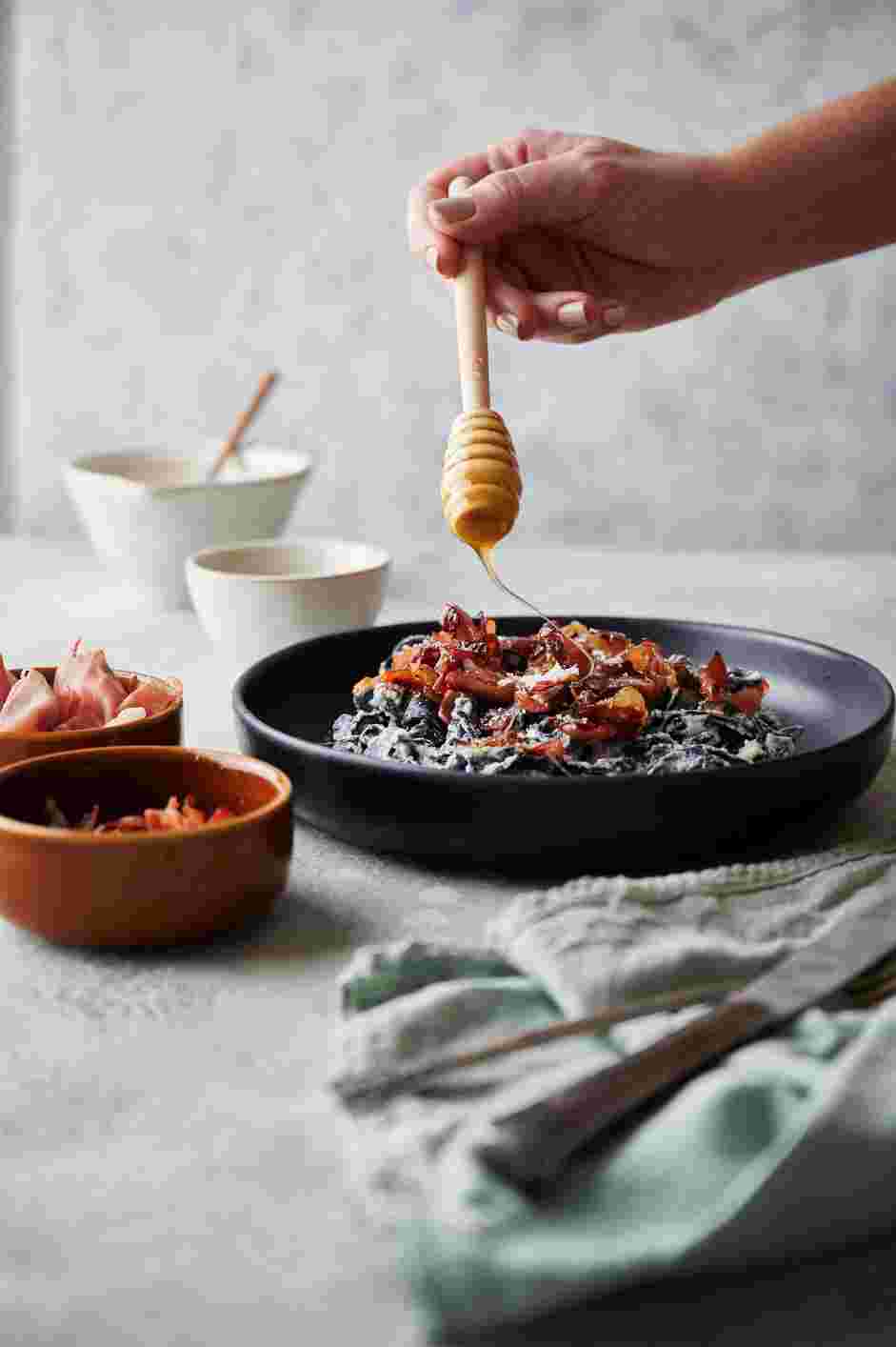 Squid Ink Pasta with Crispy Prosciutto and Truffle Honey Recipe: Garnish with shaved truffle, Parmesan or your desired garnish.