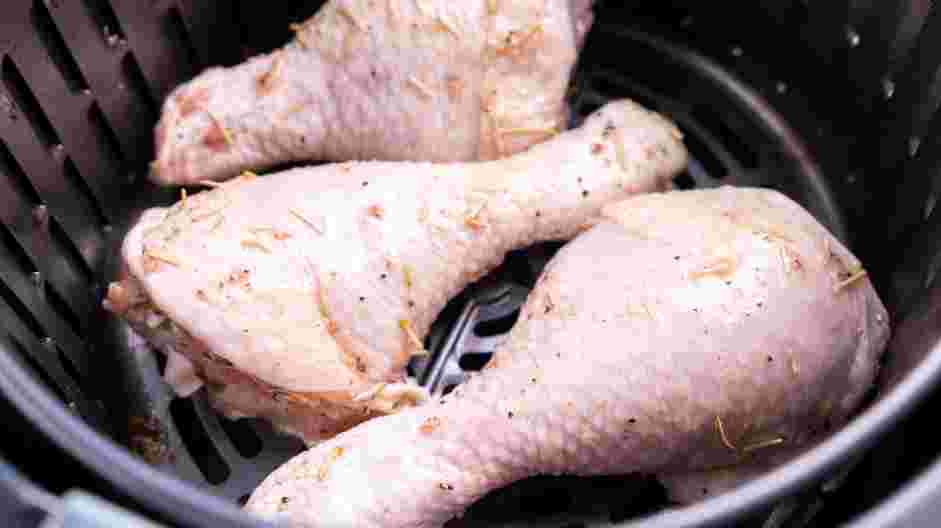 Crispy Air Fryer Chicken Recipe: Arrange the chicken legs on the prepared baking sheet or the air fryer basket.