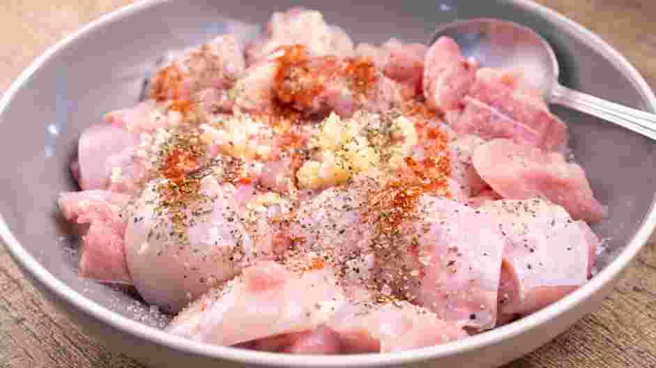 Drunken Chicken Recipe: Season the chicken thighs with minced garlic, paprika, parsley, salt and pepper.