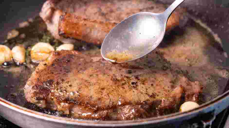 Garlic Butter Steak and Skillet Potatoes Recipe: Add the butter, garlic and thyme (or rosemary) and begin to baste the steak.