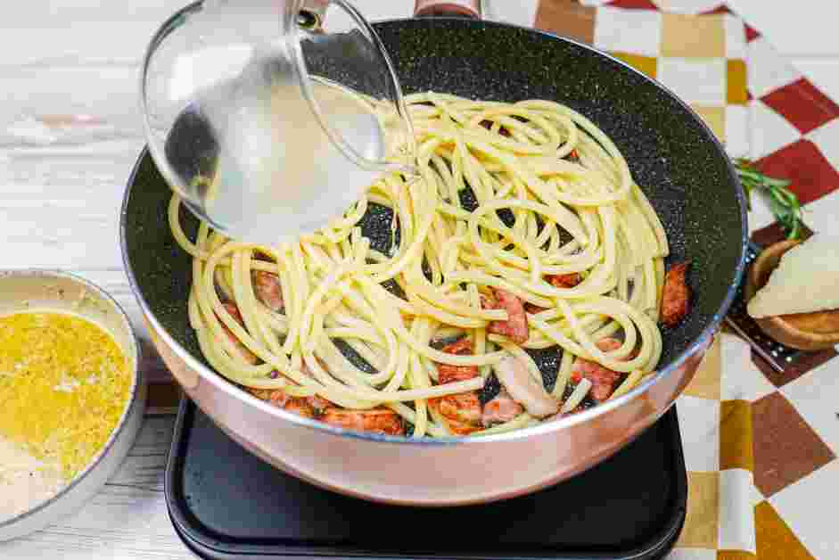 Bucatini Carbonara Recipe: Once the pasta is ready, remove it with kitchen tongs to the skillet with the guanciale and toss in the fat so it's well combined.