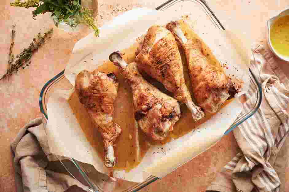 Turkey Legs Recipe: Flip the turkey legs and brush them with melted butter again.