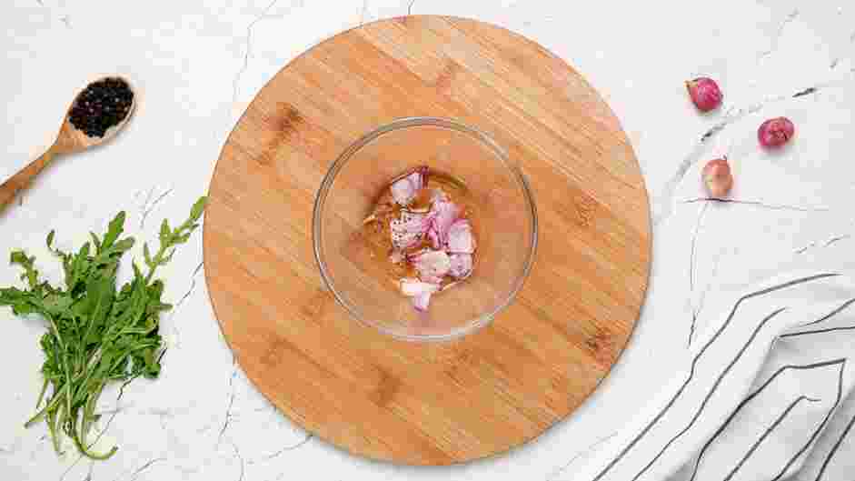 Beef Carpaccio Recipe: In a bowl, combine the thinly sliced shallot, red wine vinegar, salt and pepper.