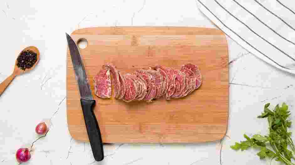 Beef Carpaccio Recipe: Use a sharp carving knife to slice the frozen tenderloin as thin as you can, about ⅛ inch thickness.