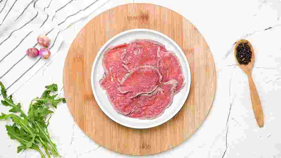 Beef Carpaccio Recipe: Place the sliced tenderloin onto four plates in a slightly overlapping single layer.