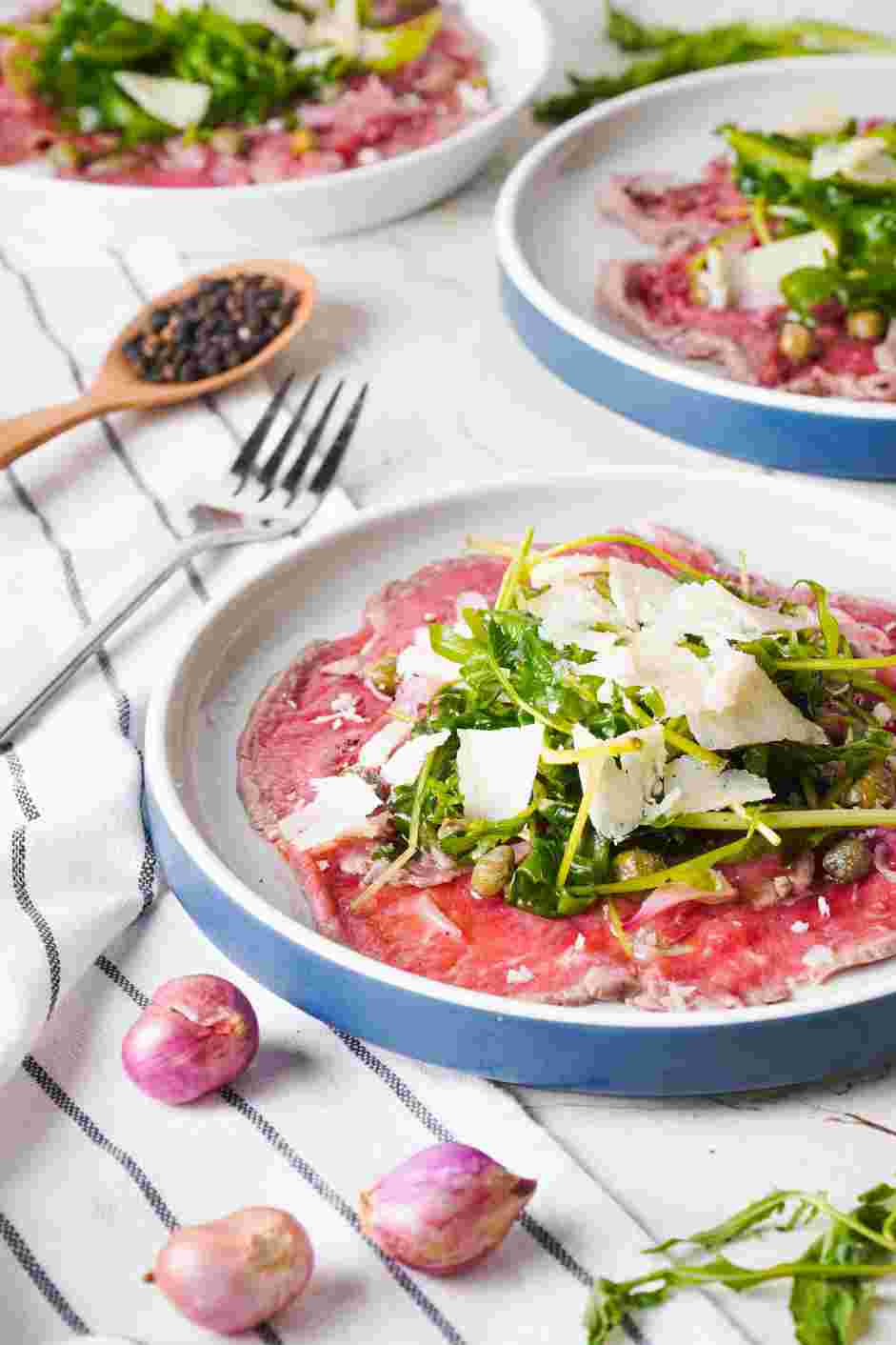 Beef Carpaccio Recipe: Plate the beef carpaccio.