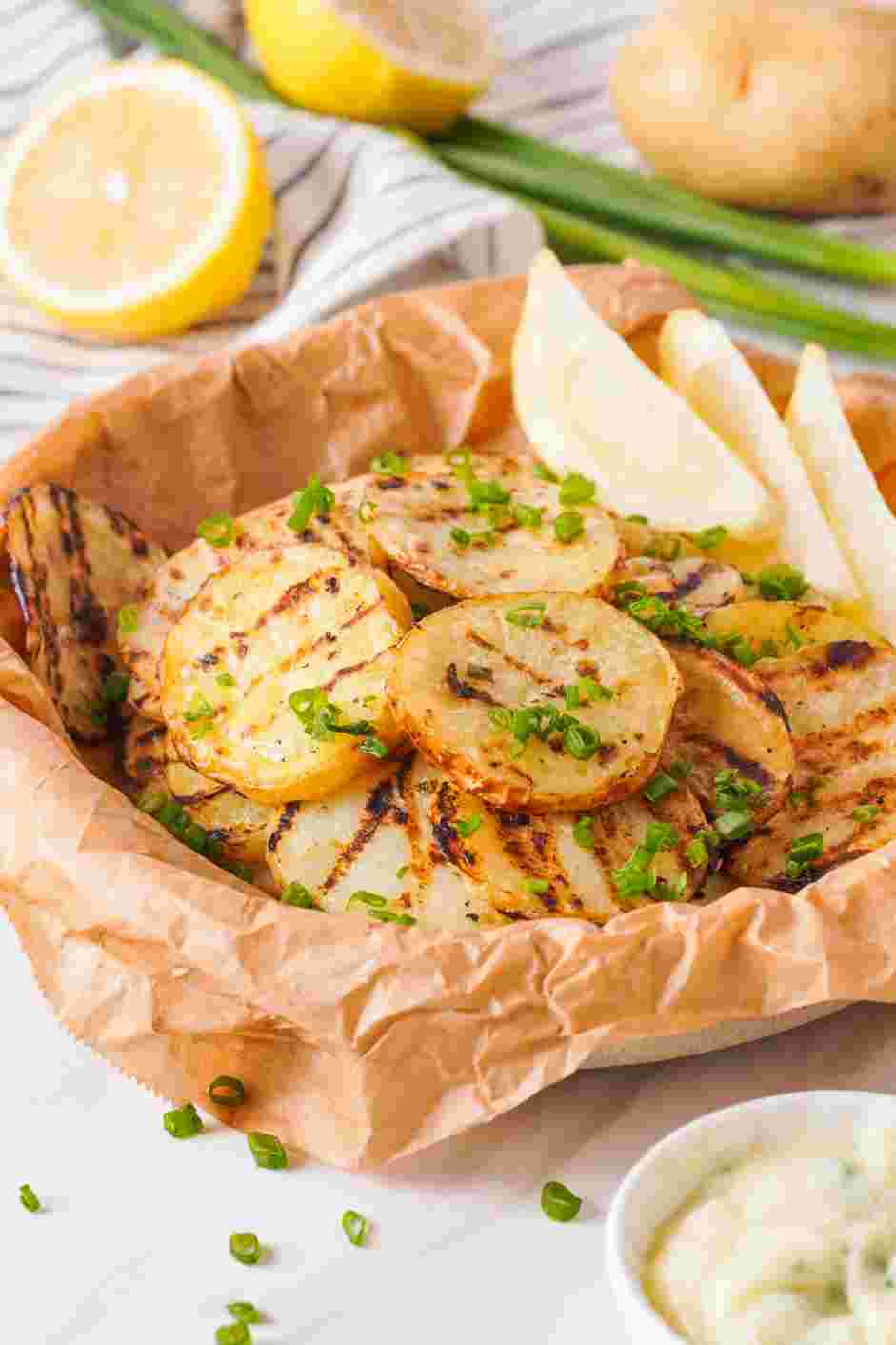 Grilled Potatoes Recipe: Plate and garnish with more chives.