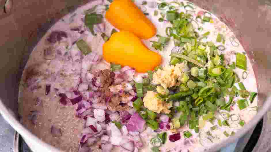 Jamaican Rice and Beans Recipe: Add the long-grain rice, diced onion, chopped scallions, grated ginger, coconut milk, scotch bonnet peppers, ground allspice and salt.