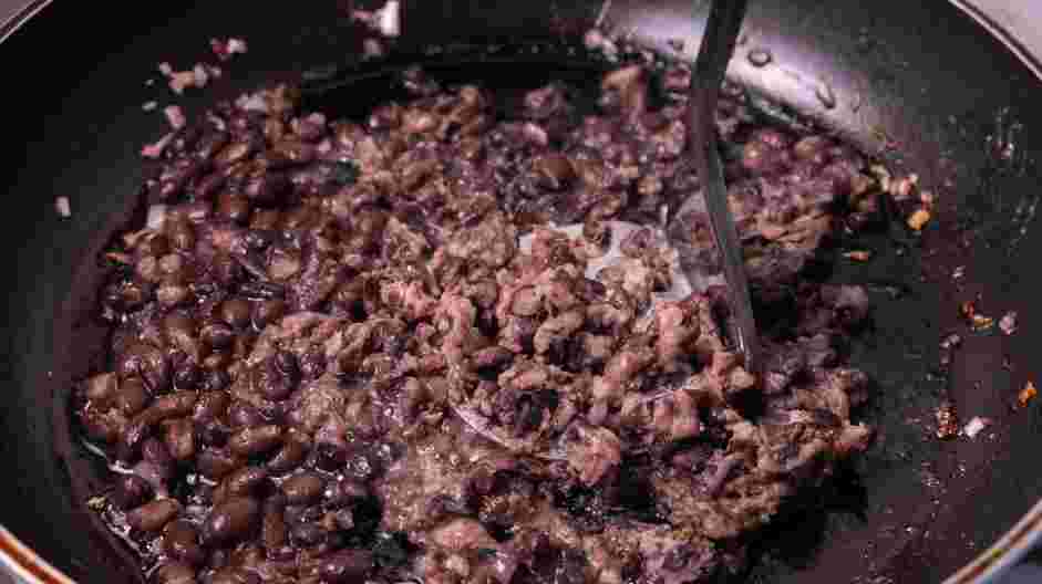 Refried Black Beans Recipe: Add the salt and keep mashing at medium heat.