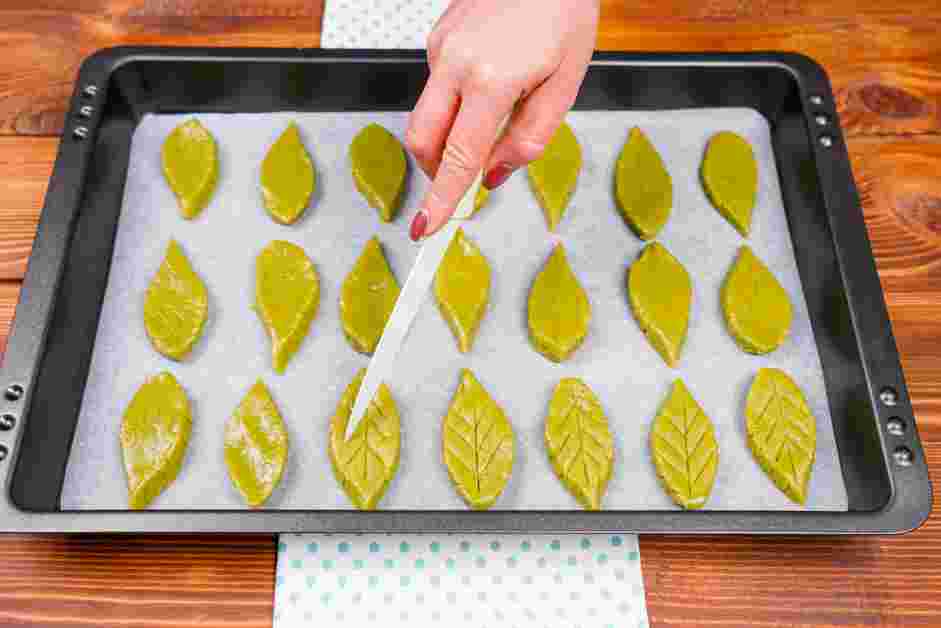 Matcha Cookies Recipe: Once the baking sheet is full of cookies, use the knife tip to score leaf veins on them, or decorate as desired.