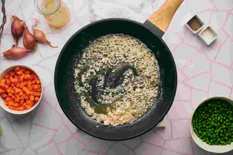 Peas and Carrots Recipe: In a skillet with a lid over medium heat, add the butter.