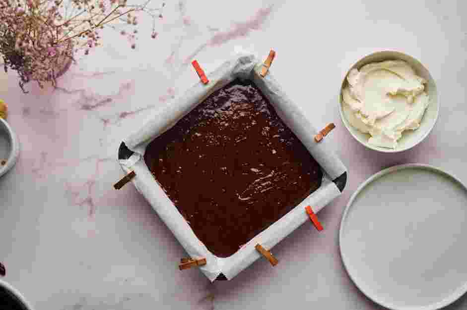 Red Velvet Brownies Recipe: Transfer the batter to the prepared baking pan and smooth out the batter with an offset spatula.