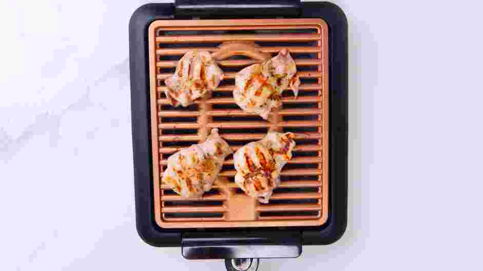 Grilled Chicken Caesar Salad Recipe: Lower the heat to medium and add the water to the grill pan.