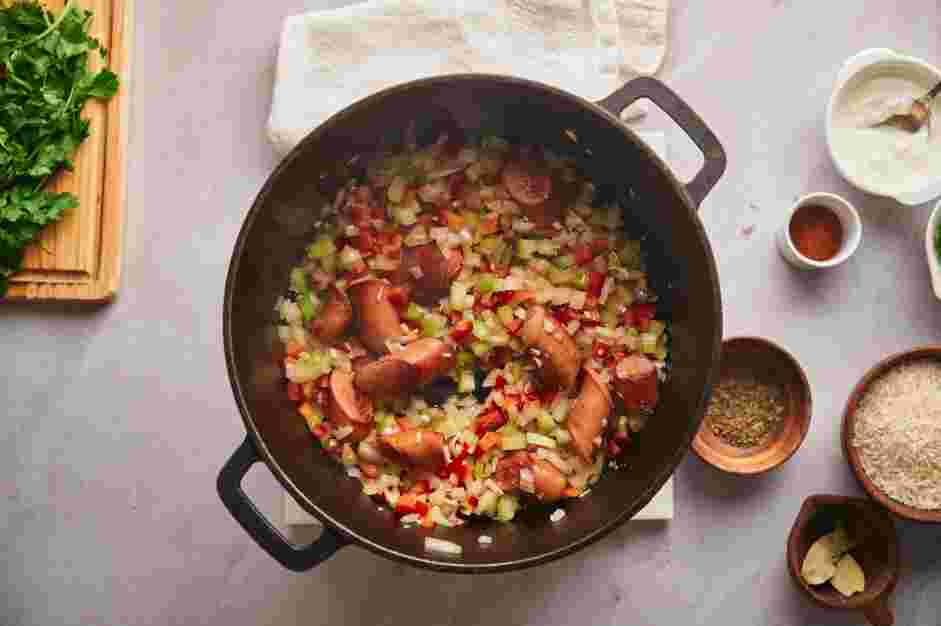 Shrimp Jambalaya Recipe: Add the chopped onion, red bell pepper, celery stalks, garlic cloves, salt and pepper.