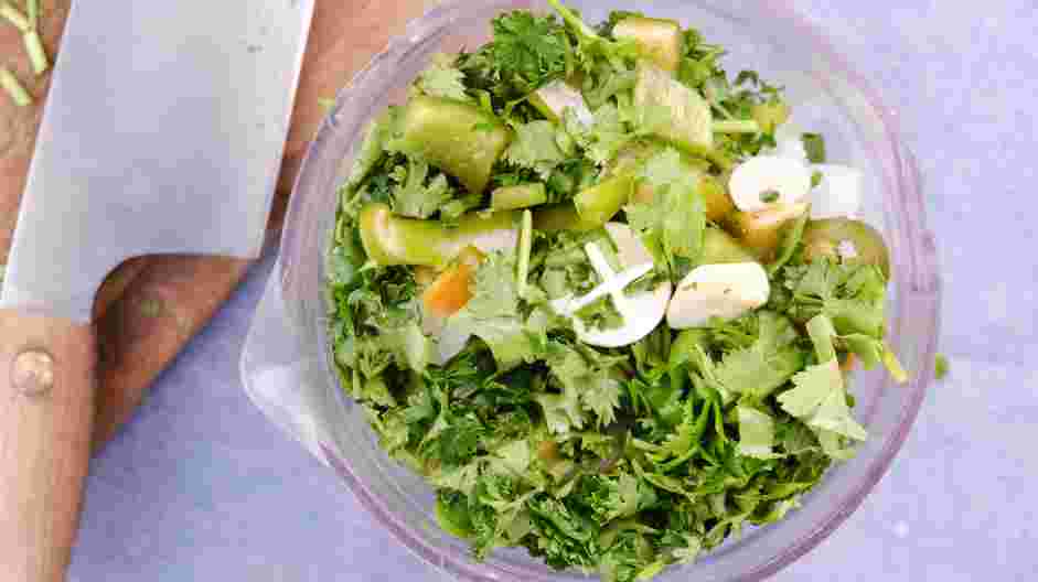 Guasacaca Recipe: In the bowl of a food processor, add the chopped onion, green bell pepper, jalapeño, garlic clove, cilantro and parsley.