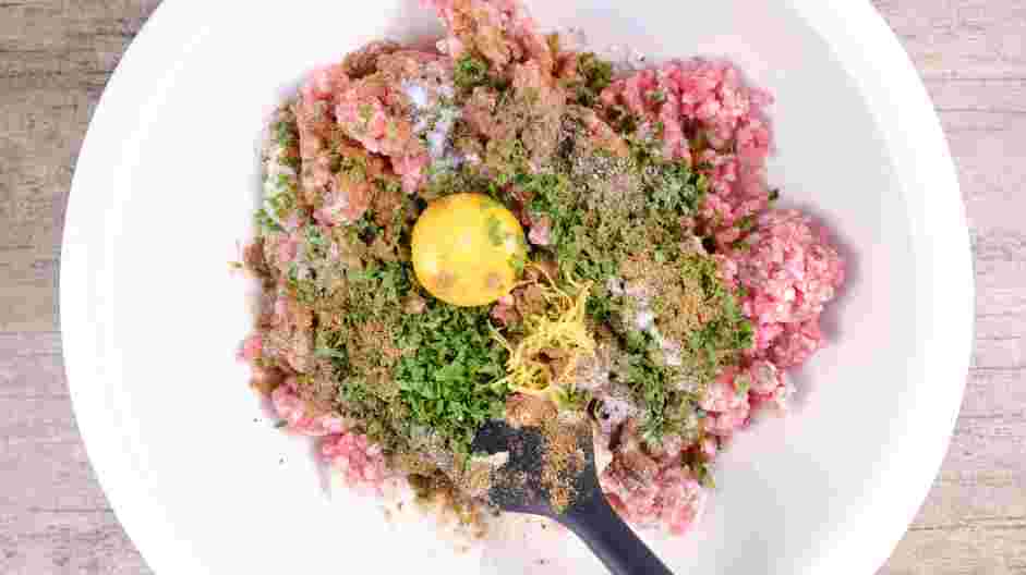 Lamb Meatballs Recipe: Add the ground lamb, fresh parsley, fresh mint, egg yolk, ground cumin, ground coriander, lemon zest, salt and pepper.