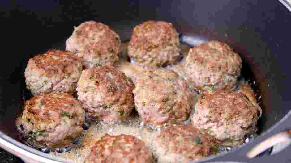 Lamb Meatballs Recipe: In a large skillet over medium heat, add the oil and heat until shimmering.