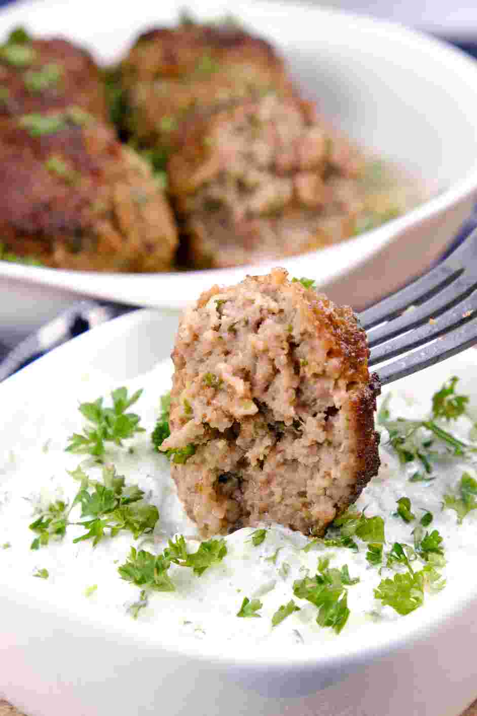 Lamb Meatballs Recipe: Garnish the meatballs with fresh parsley and serve alongside tzatziki.