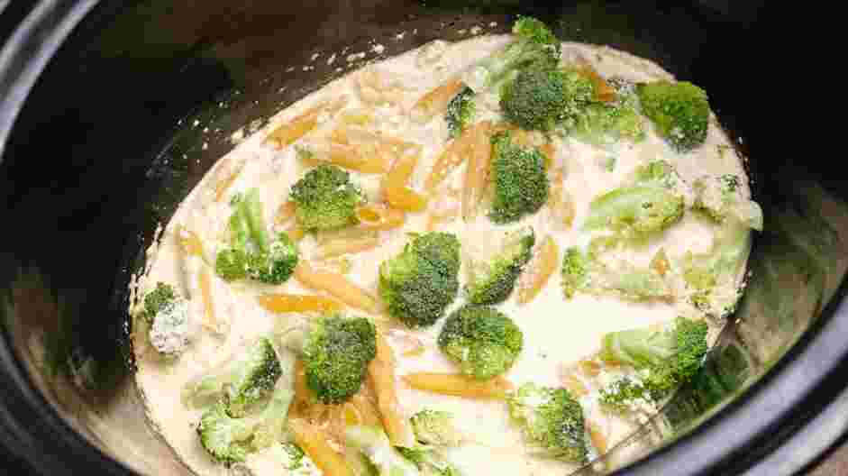 Chicken Broccoli Pasta Recipe: Add the uncooked penne pasta, shredded Parmesan cheese and broccoli florets.