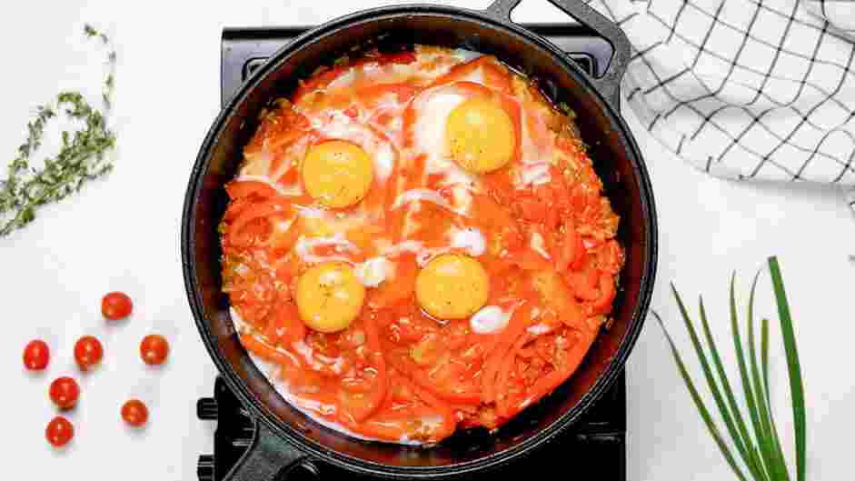 Shakshouka Recipe: After 10 minutes, stir again and crack each egg on top of the mixture.