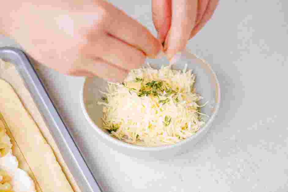 Onion Tart Recipe: Pull the leaves from the thyme sprigs and add them to the shredded Gruyere.