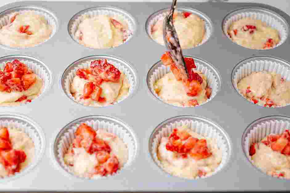 Strawberry Muffins Recipe: Sprinkle the reserved chopped strawberries on top of the muffins.