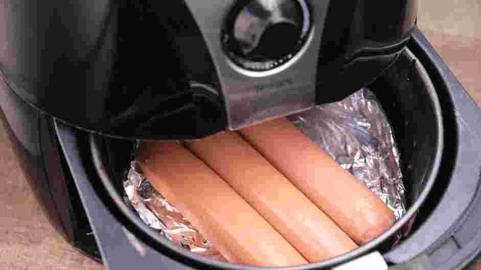 Air Fryer Hot Dogs Recipe: Line the air fryer with aluminum foil.