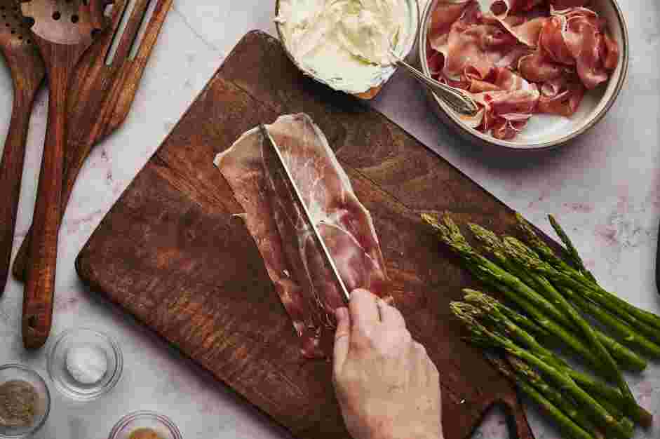 Asparagus Wrapped in Prosciutto Recipe: Carefully separate the prosciutto slices and cut them in half lengthwise.