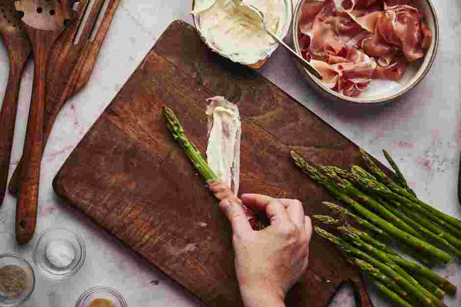 Asparagus Wrapped in Prosciutto Recipe: Place the base of the asparagus at one end of the prosciutto and carefully roll it on an angle to cover most of the stem.