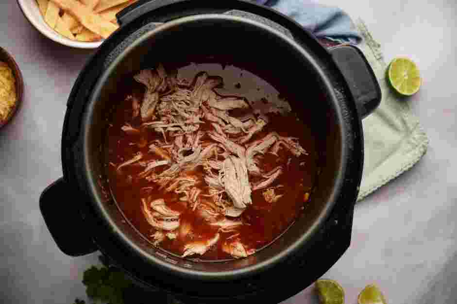 Instant Pot Chicken Tortilla Soup Recipe: Stir in the shredded chicken breasts and season with salt and pepper to taste.