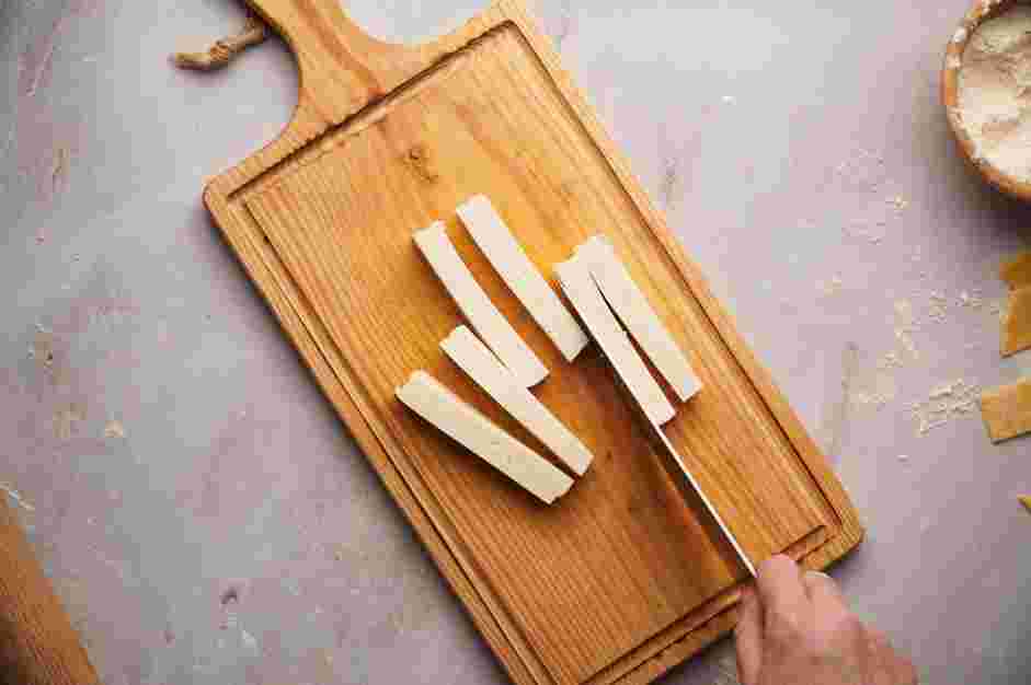 Tequenos Recipe: While the dough is resting, slice the cheese into three-inch long rectangular sticks that are about ½ inch wide.