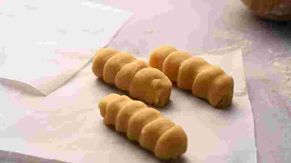 Tequenos Recipe: Place the wrapped cheese sticks on a baking sheet lined with parchment paper.