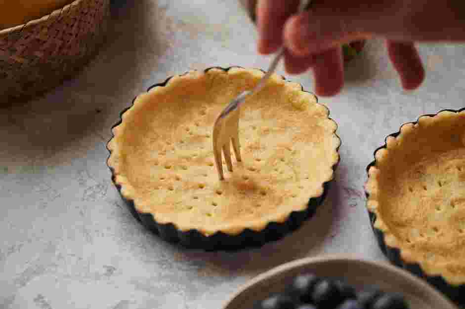 Lemon Curd Tart Recipe: Spread the dough into six 4-inch tart pans.