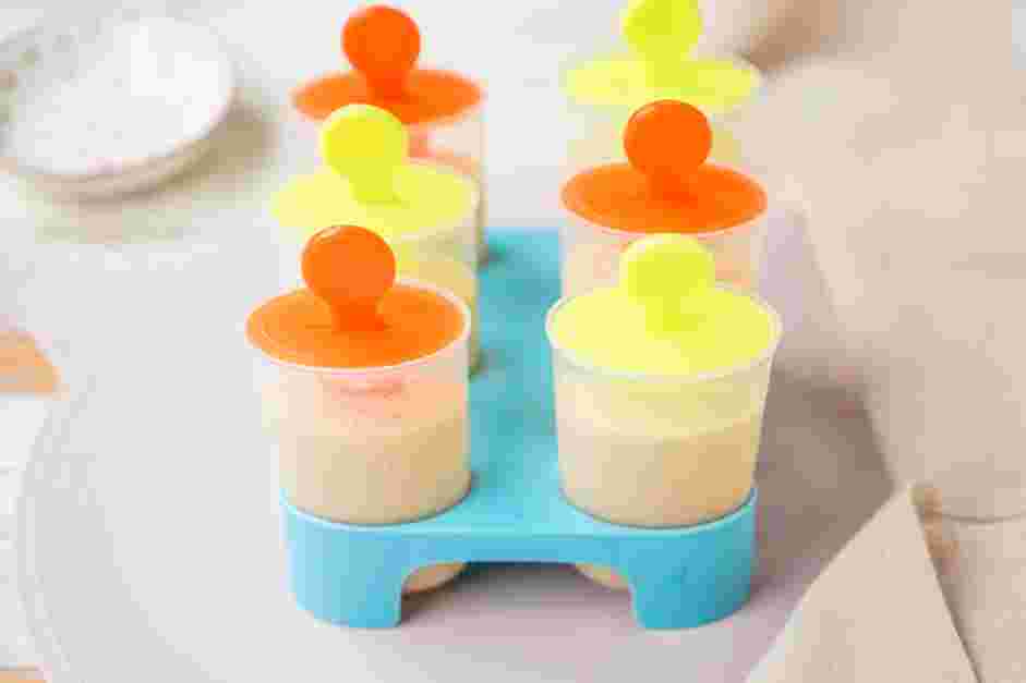 Banana Popsicles Recipe: Fill each popsicle mold &frac34; of the way with the strawberry mixture.