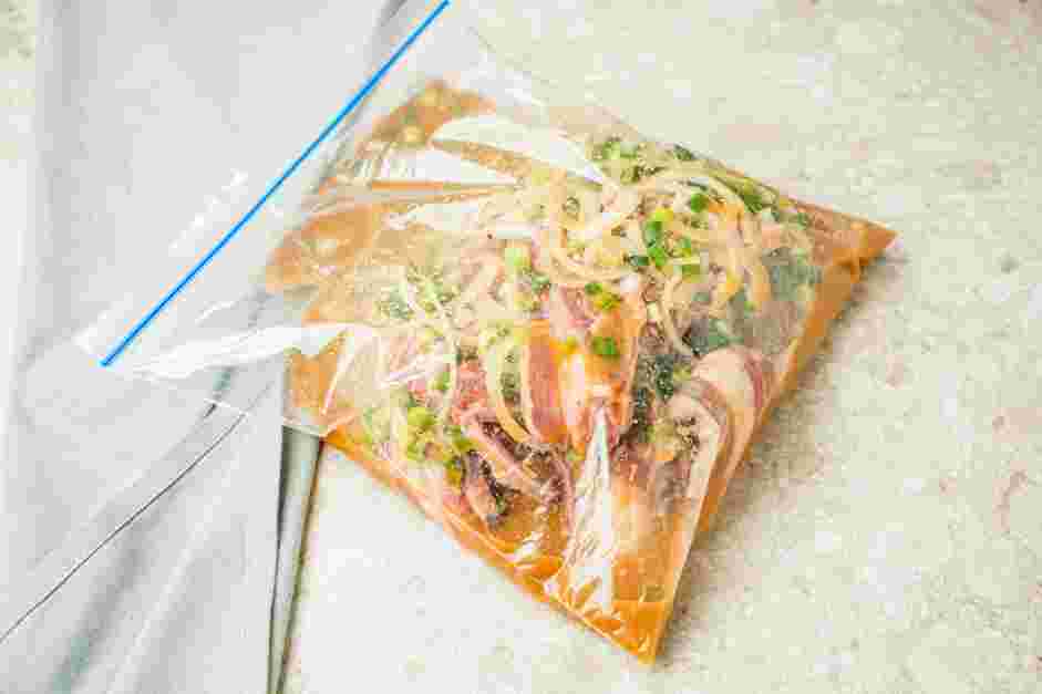 LA Galbi Recipe: In a large plastic zip-top bag, add the short ribs, thinly sliced onion and green onions.