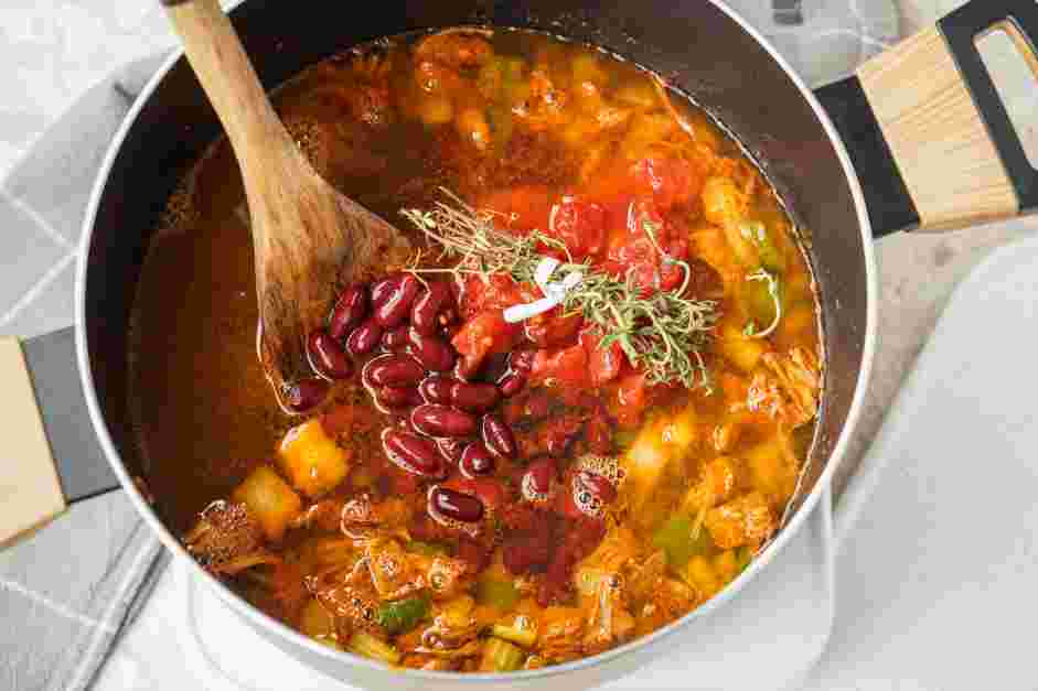 Vegan Gumbo Recipe: Pour the vegetable stock, red kidney beans, fire roasted tomatoes and red wine vinegar into the pot.