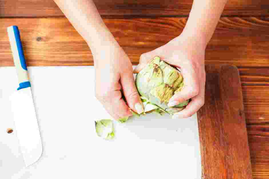 How to Cook Artichokes Step 1: Prepare the artichokes by slicing off the top and stem and removing any tough leaves from around the base.