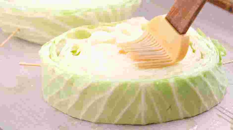 Cabbage Steaks Recipe: Brush the three tablespoons of olive oil over the sliced cabbage and season with kosher salt and freshly ground pepper.