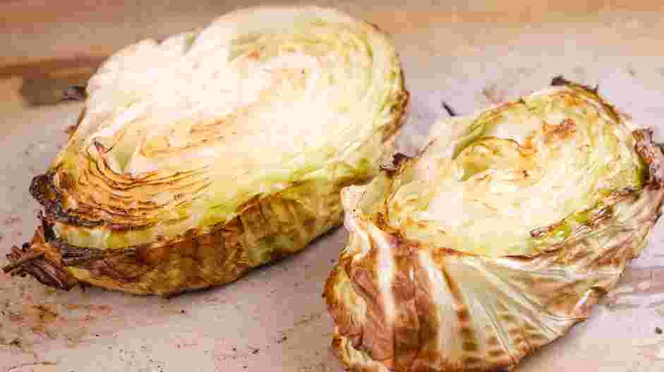 Cabbage Steaks Recipe: Remove the sheet pans from the oven and flip the cabbage steaks over.