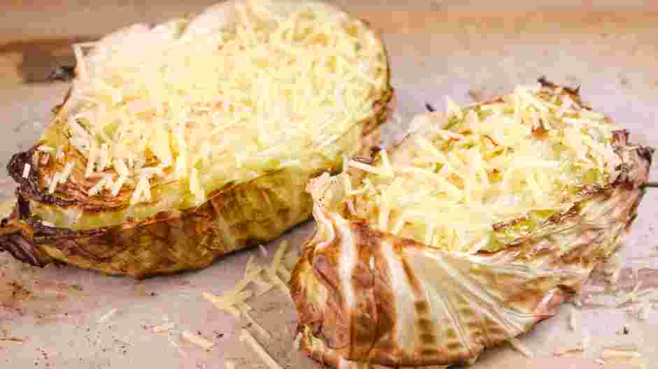 Cabbage Steaks Recipe: Remove the cabbage steaks from the oven and generously grate the Parmesan cheese over the steaks.