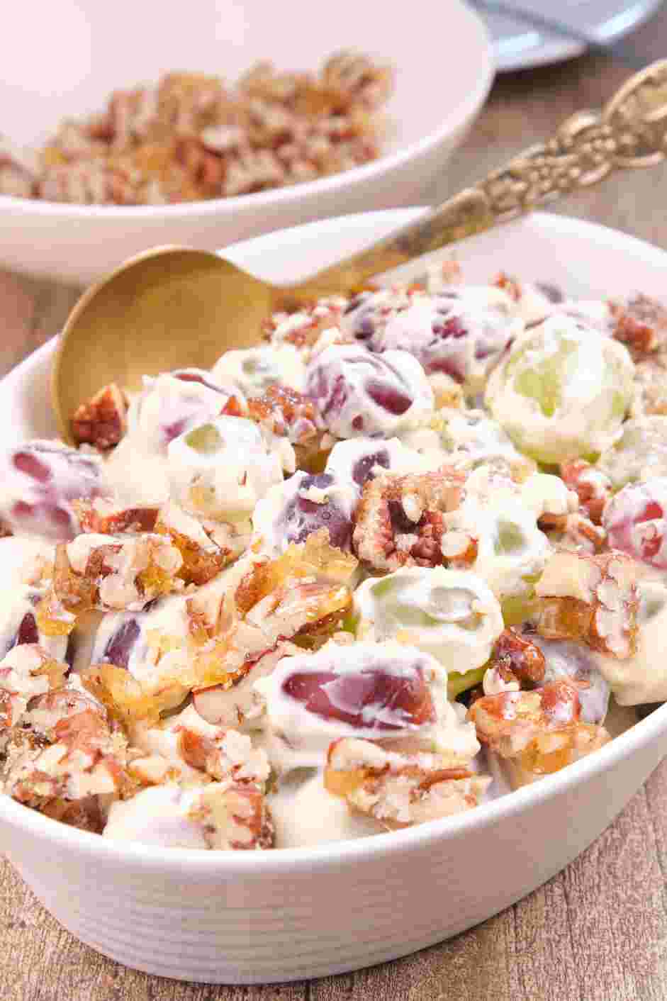 Grape Salad Recipe: When ready to serve, transfer the grape salad into a serving bowl and sprinkle the candied pecans over the top.