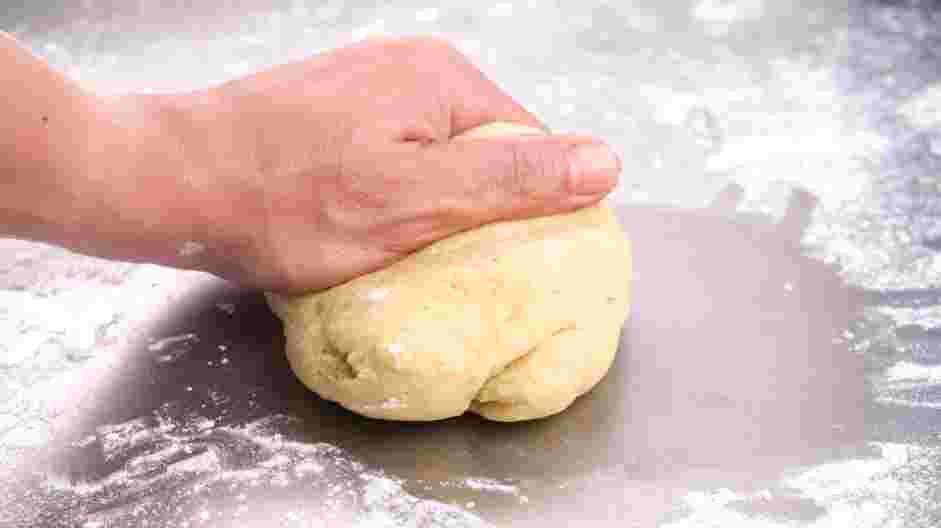 Tagliolini with Tomato Pomodoro Recipe: Remove the fork and use your hands to form the flour and egg mixture into a ball.