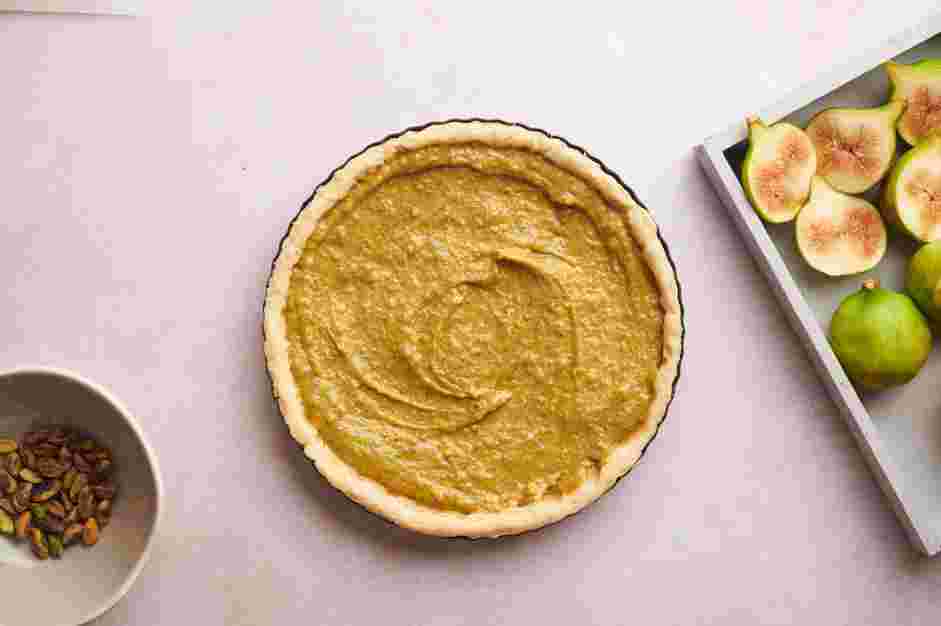 Fig Tart Recipe: Add the pistachio cream into the cooled tart shell and spread evenly with a spatula.