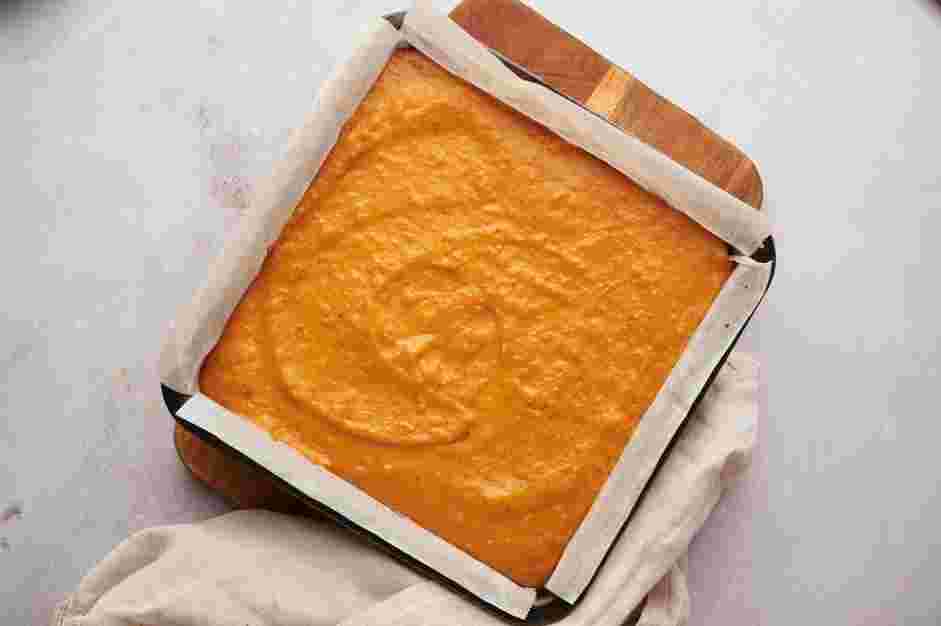 Pumpkin Cheesecake Bars Recipe: Once the cheesecake layer is set, top the cheesecake layer with the pumpkin pie filling.