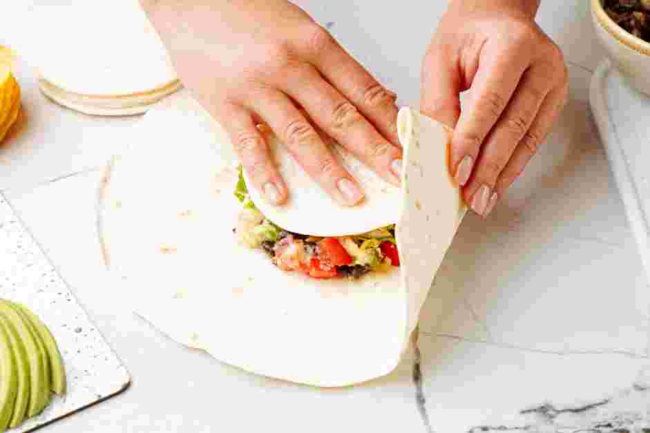 Black Bean Crunchwrap Supreme Recipe: Place the small flour tortilla over the corn tortilla.