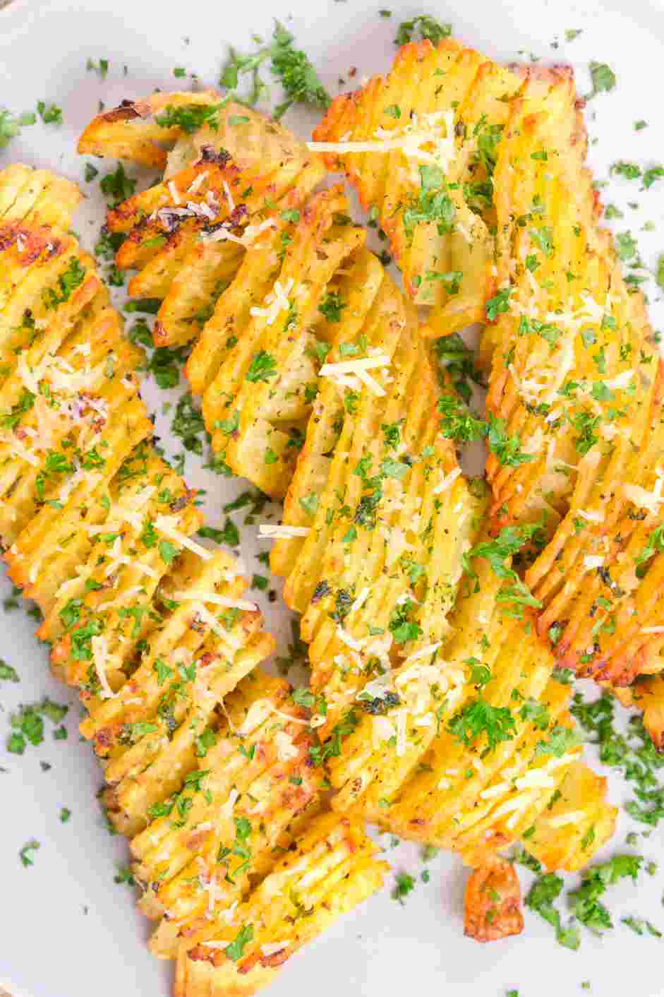 Accordion Potatoes Recipe: Grate some Parmesan cheese over the potatoes and garnish with finely chopped fresh parsley.