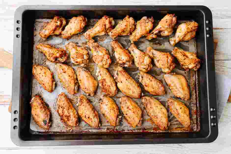 Garlic Parmesan Wings Recipe: Remove the roasted garlic from the oven and place the chicken wings.